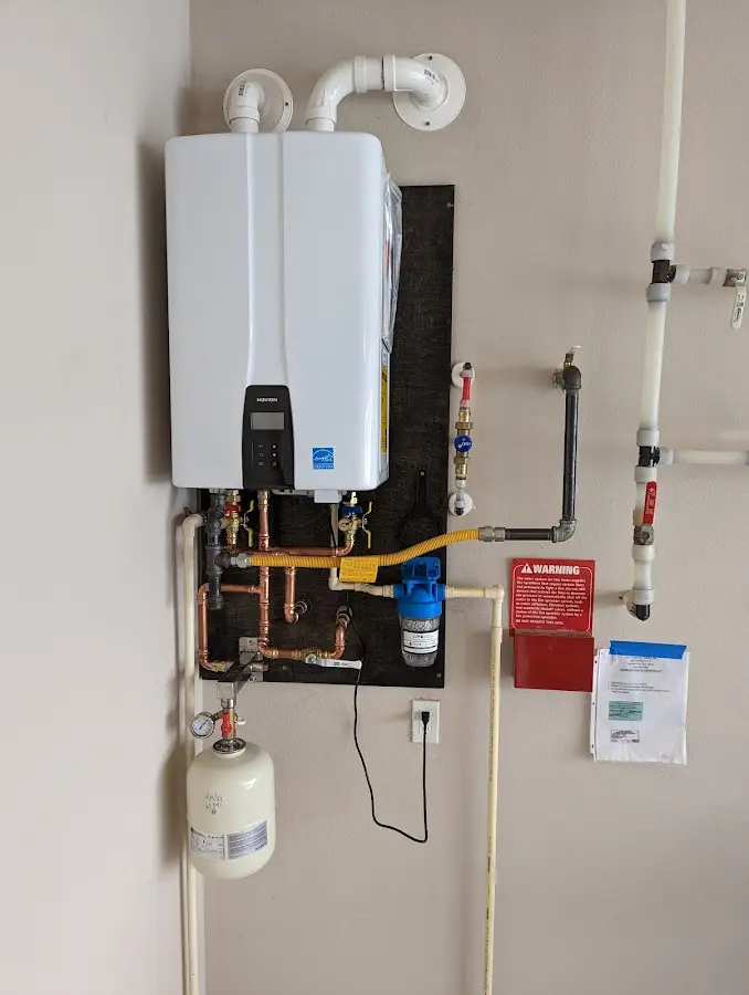 Professional plumber installing copper piping in a Stanford home